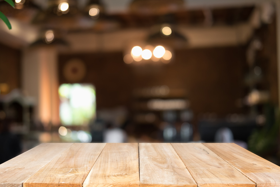 Empty Wooden Table on   Blurred Restaurant Background 